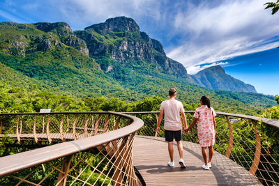 Rear view of man walking on mountain