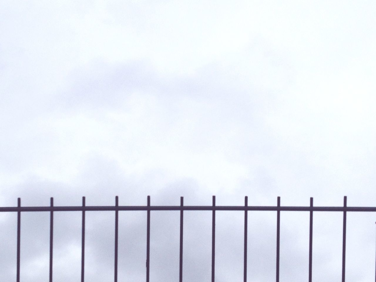 copy space, fence, metal, sky, protection, safety, railing, clear sky, low angle view, backgrounds, pattern, security, day, in a row, repetition, no people, outdoors, full frame, metallic, side by side