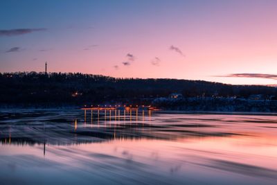 Scenic view of frozen lake against sky at sunset