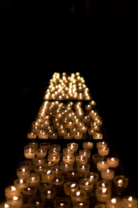 Close-up of illuminated lighting equipment against black background