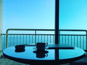 Coffee cup on table by window