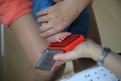 Midsection of woman using mobile phone