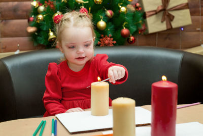 A small child sits at the new year's festive table.