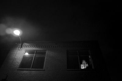 Low angle view of illuminated street light at night