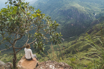 Woman sitting on mountain