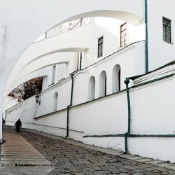 Footpath amidst buildings in city