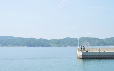 Scenic view of sea with mountains in background