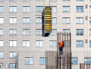 Low angle view of men working on building