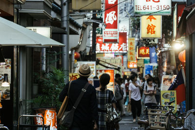 People in market by banners