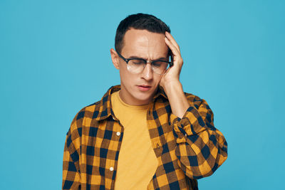 Portrait of mid adult man against blue background