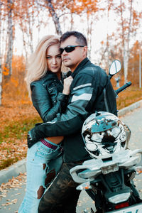 Young couple kissing in park during autumn