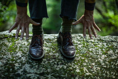 Low section of men standing on plant