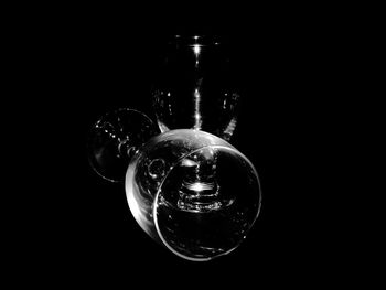 Close-up of light bulb over black background