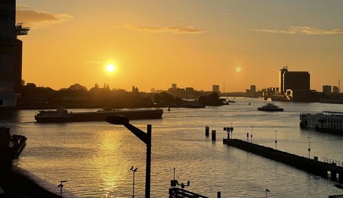 Scenic view of river against sky during sunset