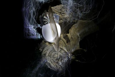 High angle view of illuminated lighting equipment against black background