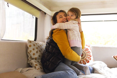 Mother and daughter embracing in motor home