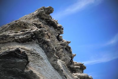 Low angle view of rock formation against sky