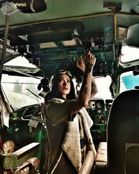 Portrait of young woman taking selfie in bus