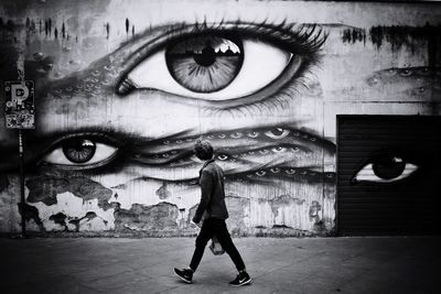 Portrait of man with graffiti on wall