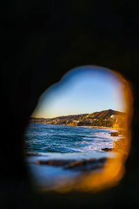 View of illuminated beach at sunset