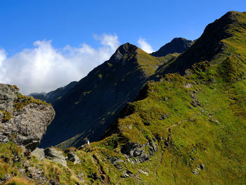 Scenic view of mountains against blue sky