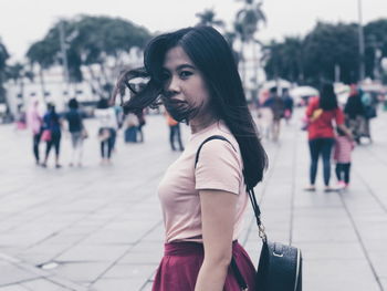 Portrait of young woman walking outdoors