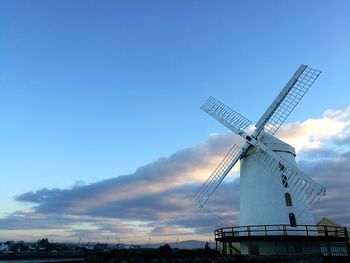 Windmill against clear blue sky