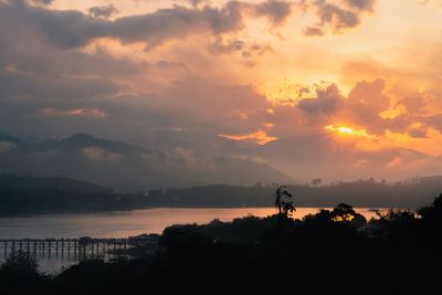 Scenic view of silhouette mountains against sky during sunset