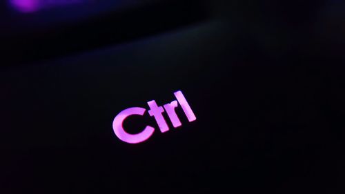Close-up of illuminated text against black background