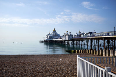 Eastbourne seafront and pier, east sussex, england. an early morning with calm water.