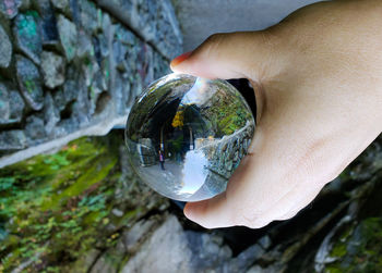 Close-up of hand holding crystal ball