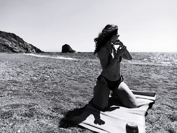 Full length of woman on beach against sky