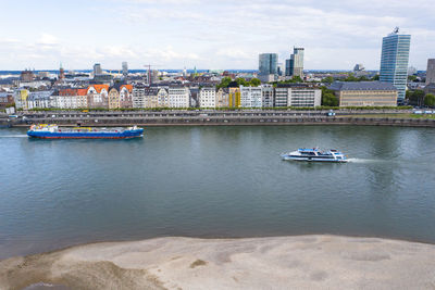 Scenic view of river and buildings in city