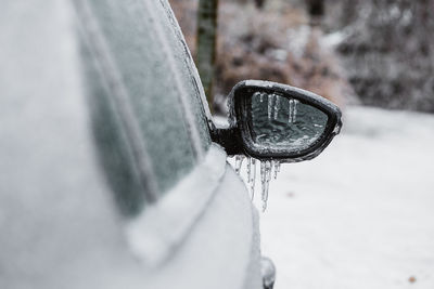 Close-up of snow on metal wheel