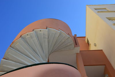 Zoom on a spiral staircase with blue sky background