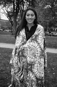 Young woman with shawl standing at park