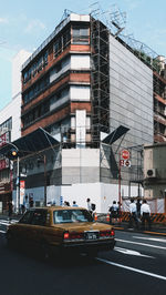 Cars on road against buildings in city