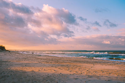 Scenic view of beach against sky during sunset