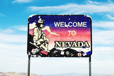 Information sign against sky