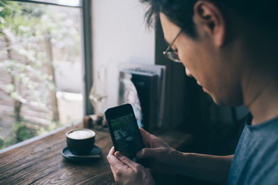 Midsection of man using mobile phone