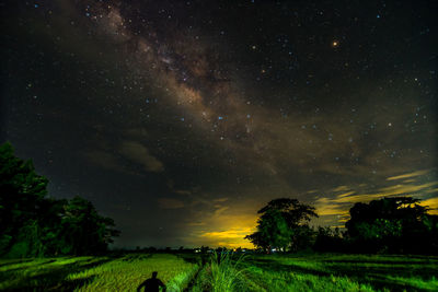 Milky way over green landscape at night