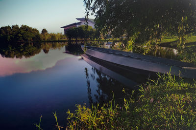 Scenic view of lake by trees against sky