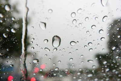 Full frame shot of wet glass window in rainy season