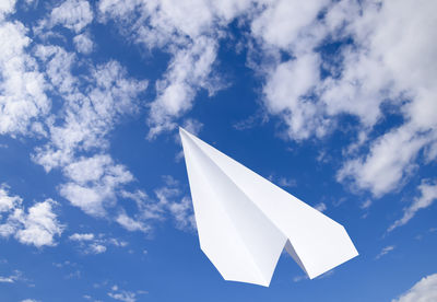 Low angle view of umbrella against blue sky