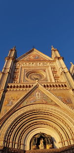 Low angle view of building against clear blue sky