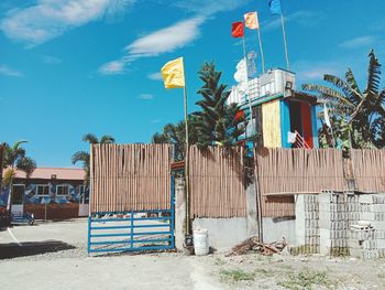 Built structure on beach by buildings against blue sky