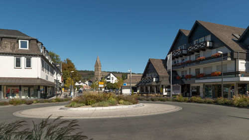 The city of olsberg photographed from the market. new traffic circle, shops, restaurant and  church