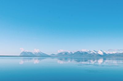 Scenic view of calm lagoon against blue sky