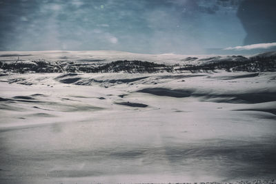 Scenic view of snowcapped landscape against sky