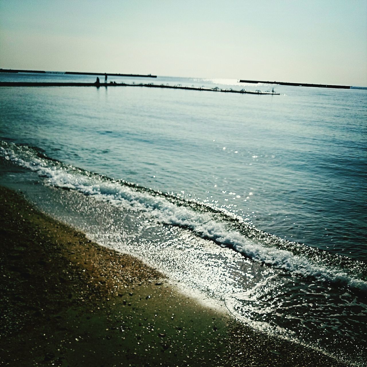 sea, water, horizon over water, beach, scenics, tranquil scene, wave, tranquility, shore, beauty in nature, clear sky, nature, sand, surf, idyllic, sky, rippled, coastline, remote, silhouette